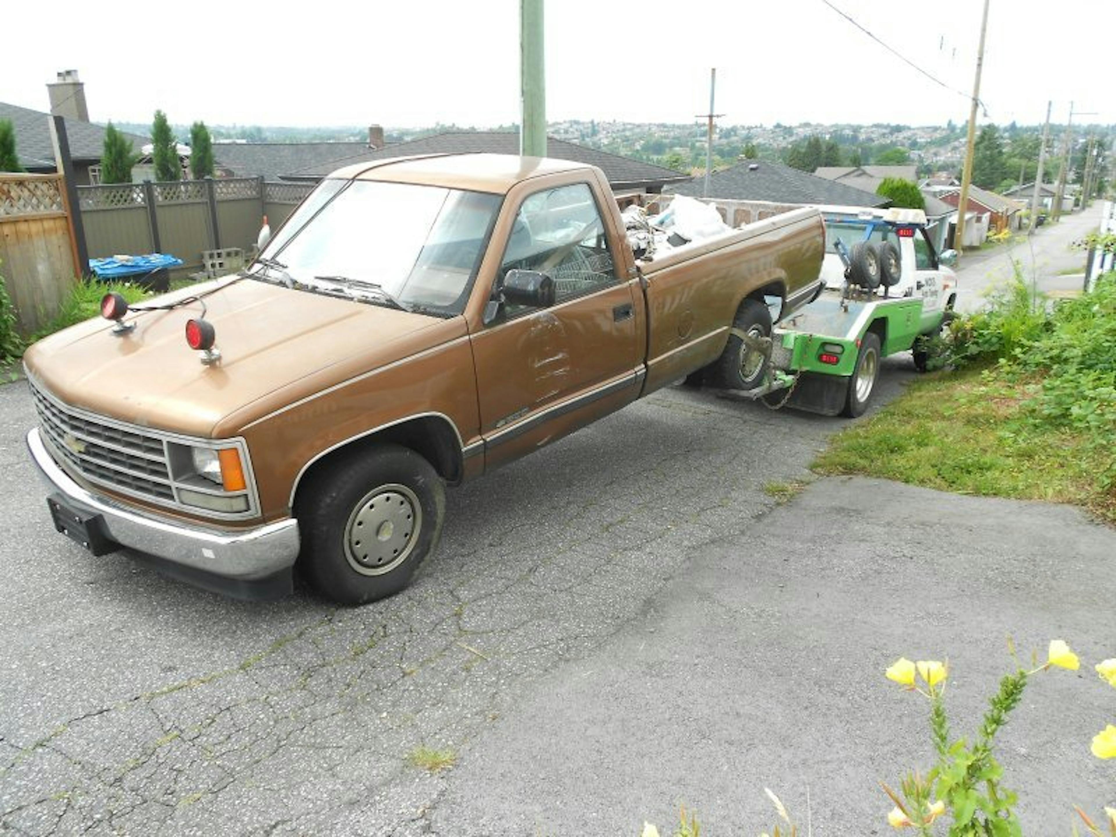 Nick's Auto Towing picking up a Chevy truck.