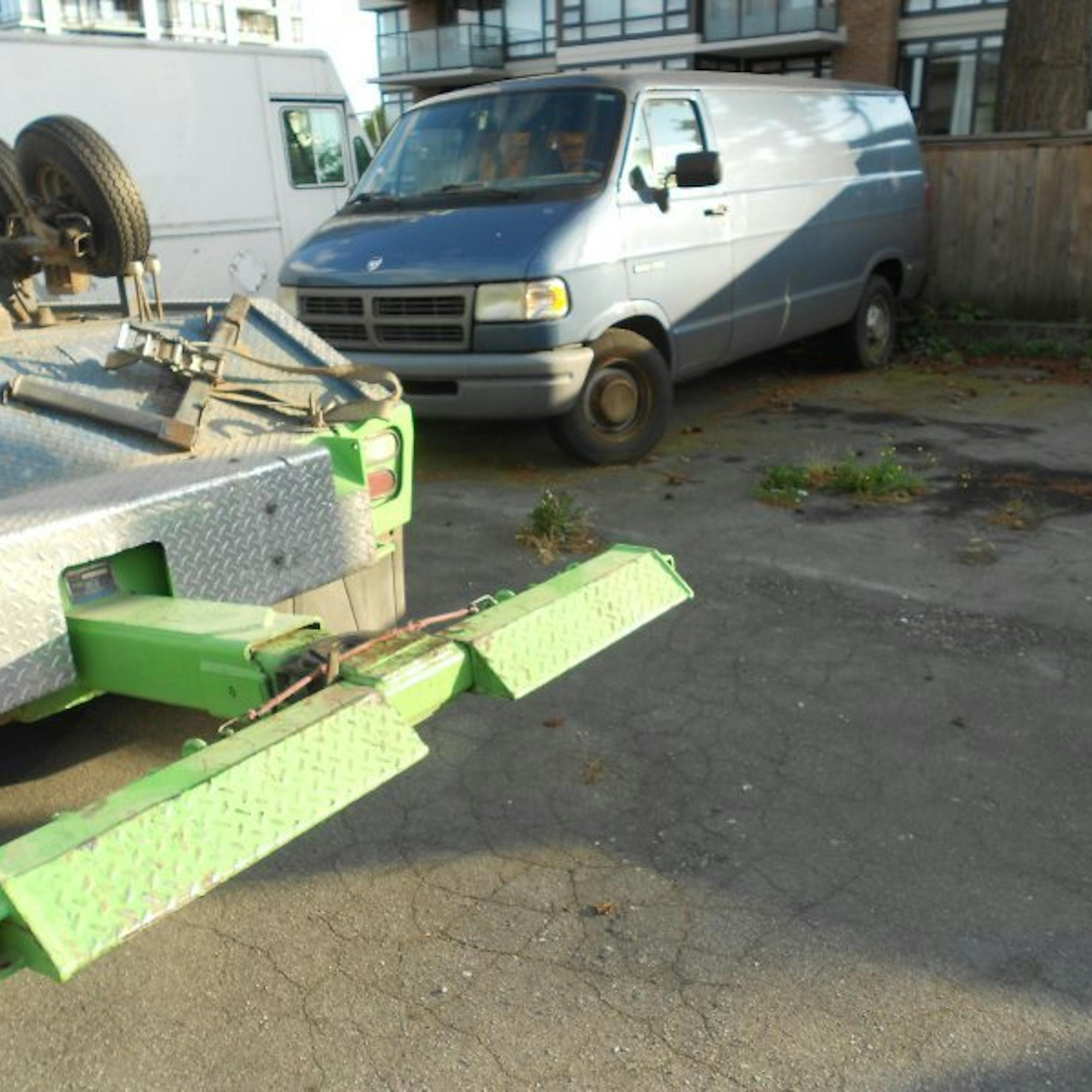 Nick's Auto Towing picking up a Dodge van.