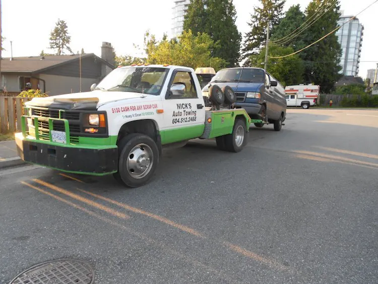 Nick's Auto Towing picking up a Dodge van.
