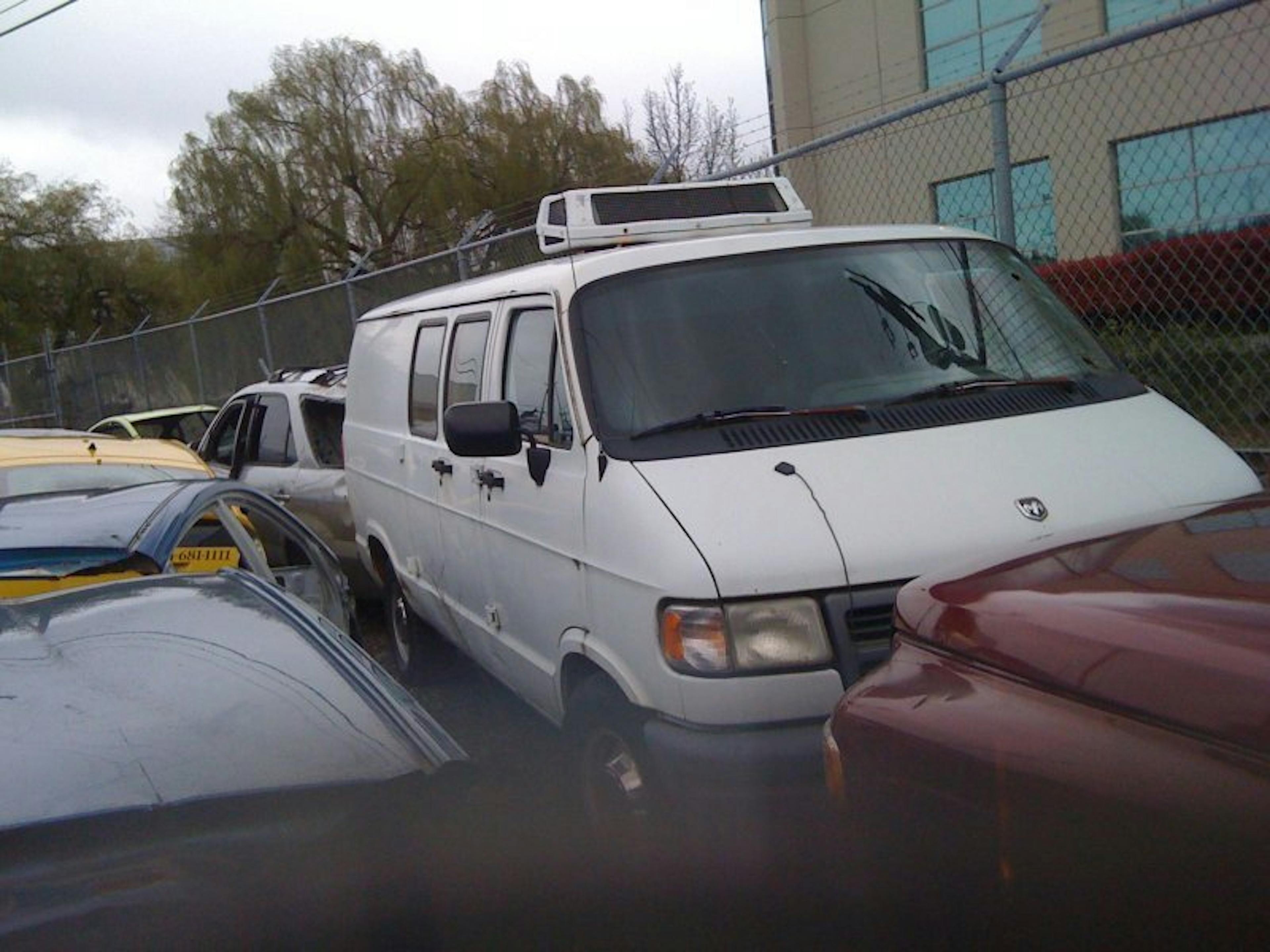Nick's Auto Towing picking up a Dodge van.