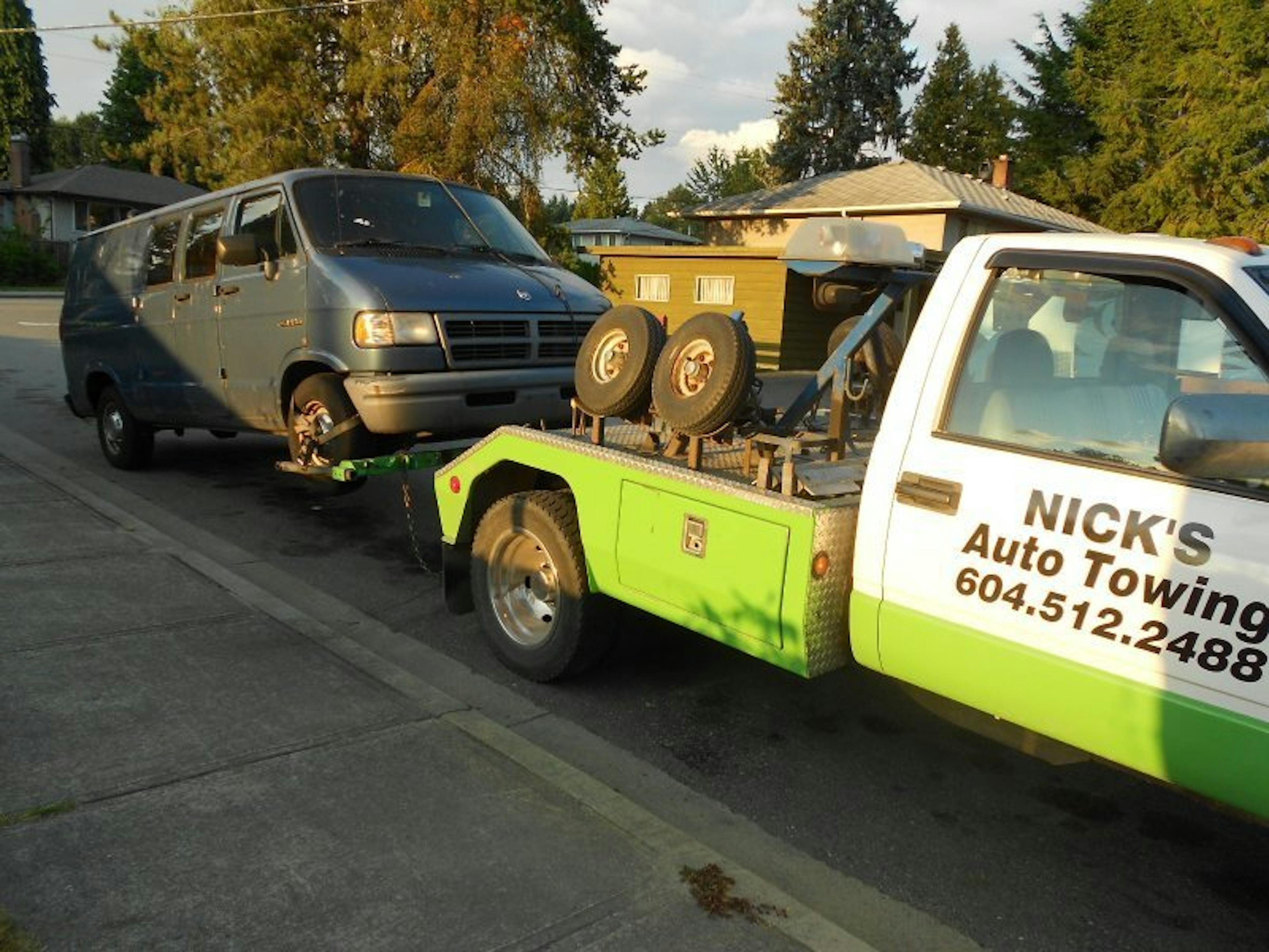 A scrap van being towed by Nicks Green Auto Towing