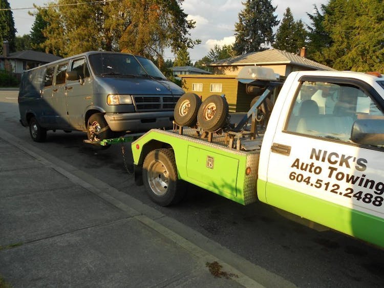A scrap van being towed by Nicks Green Auto Towing