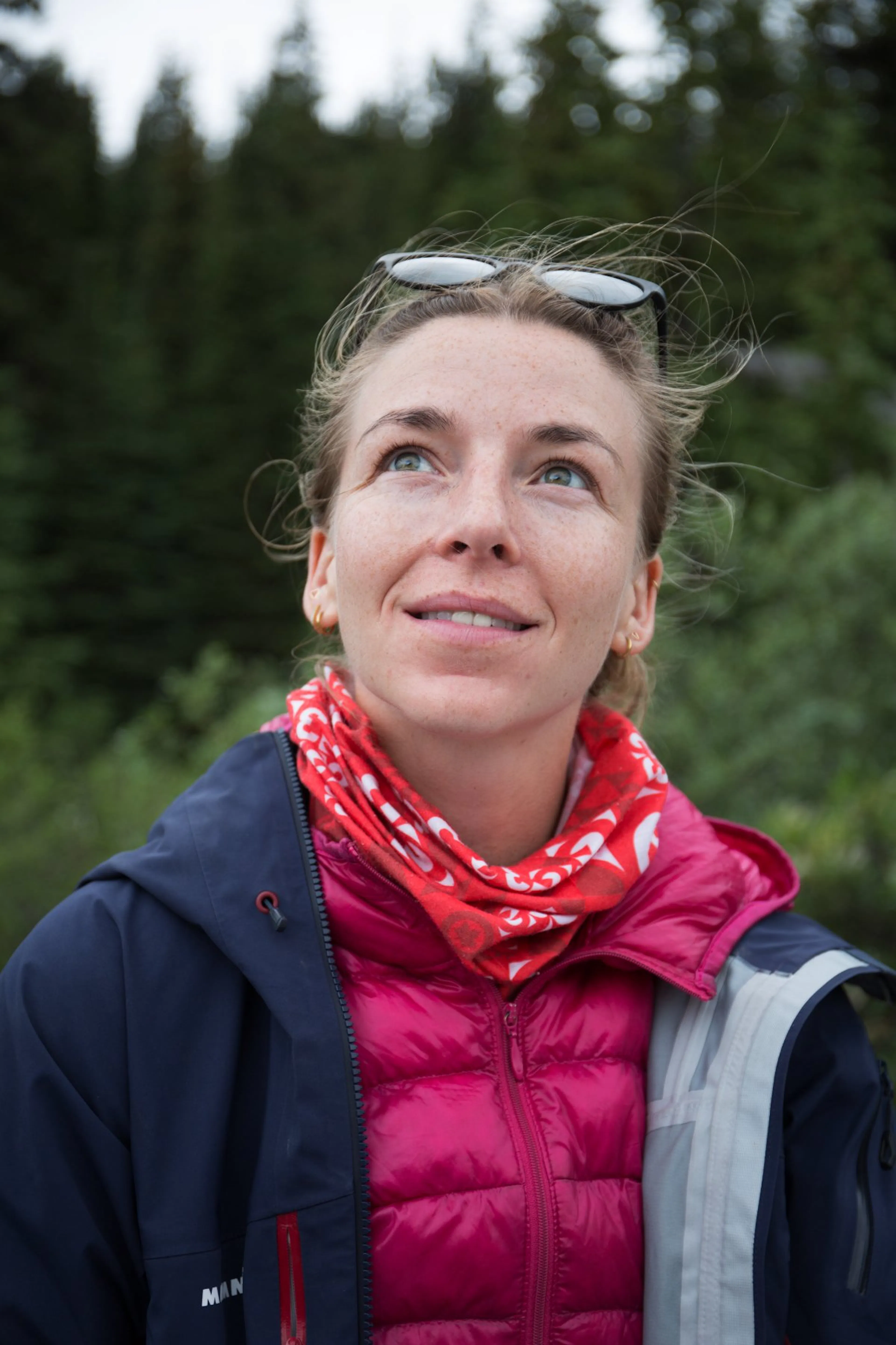Profile photo of Nicola Parker outdoors in a pink jacket, looking at the sky.