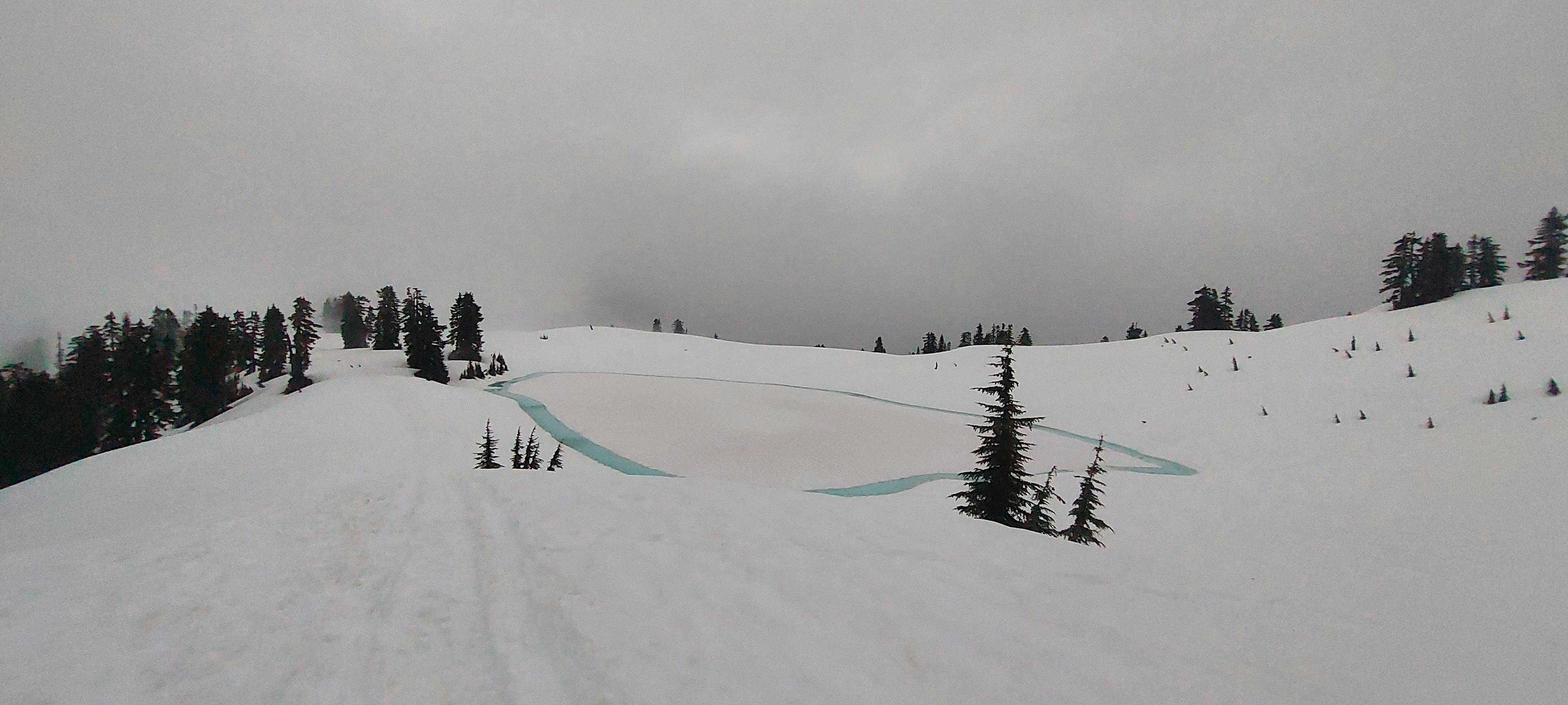 Semi-frozen Elfin Lakes in the clouds.