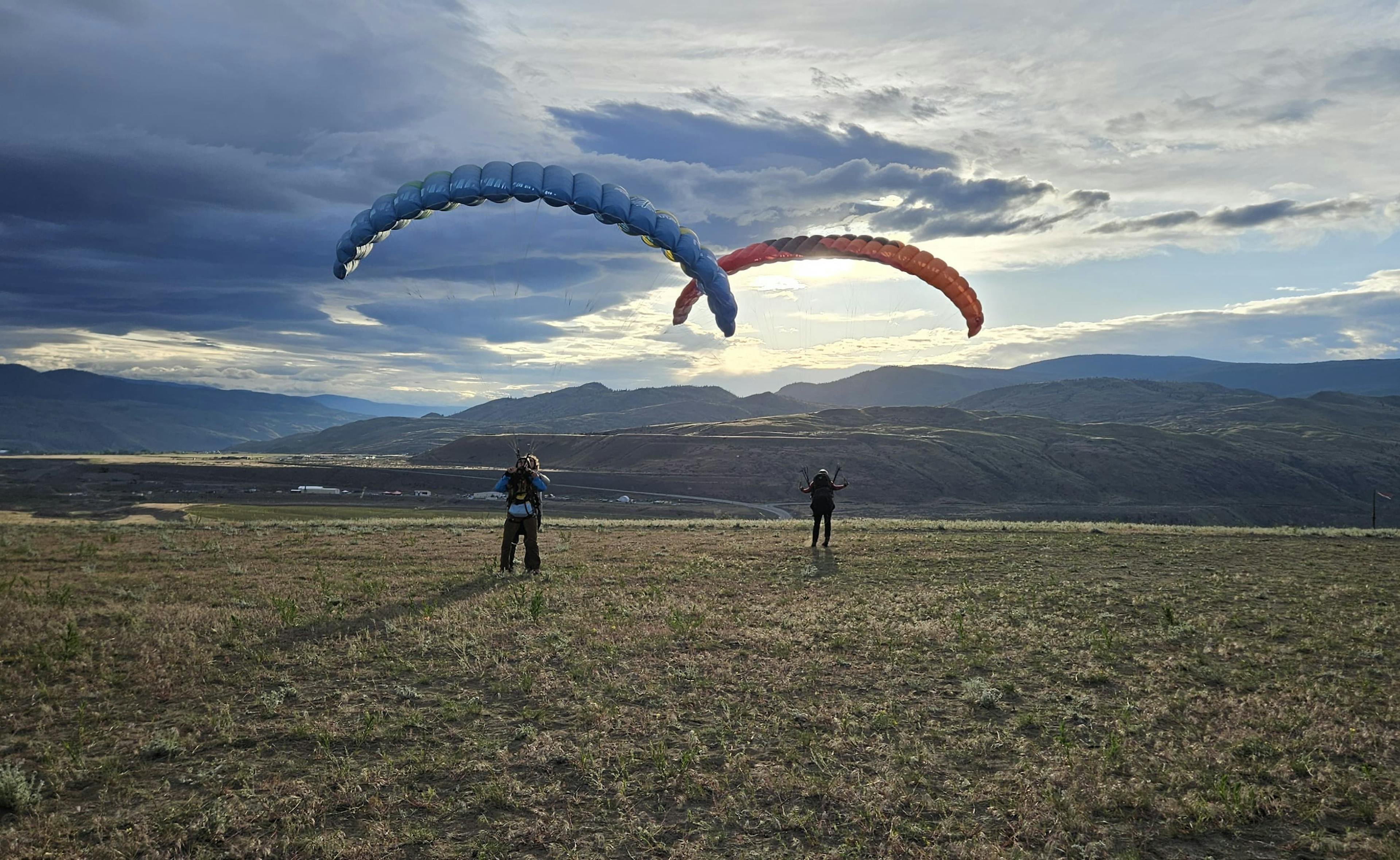 Photo cred: someone else. Photo of two paragliders ground handling. 