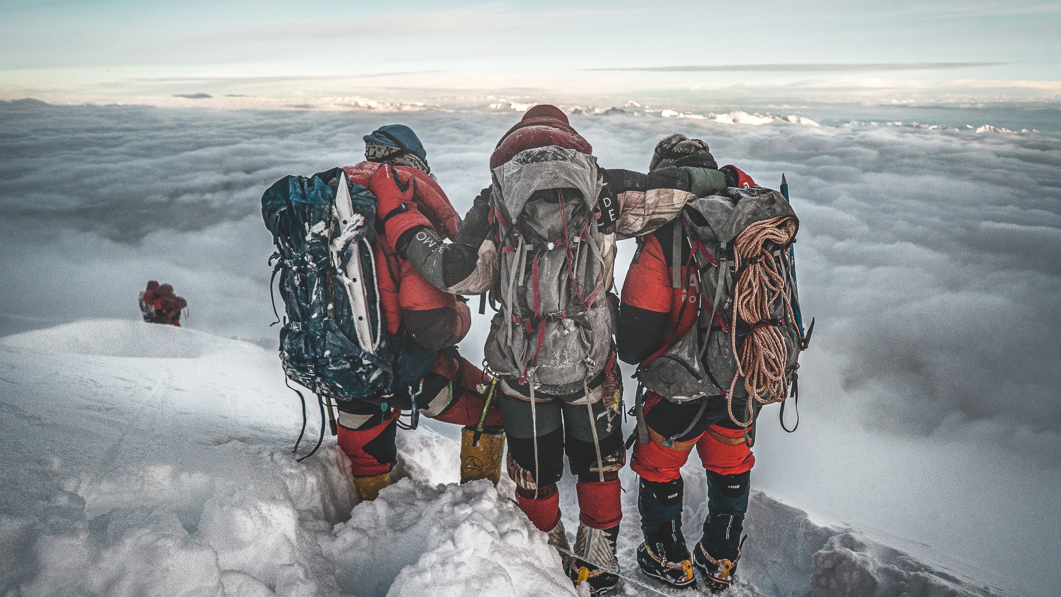 ‘Mission Achieved’, Nims stands arm in arm with his teammates on the 14th summit of Shishapangma  8,013m