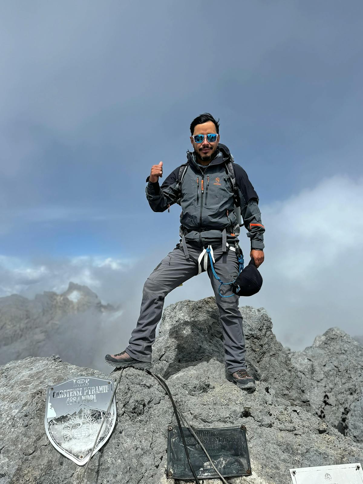 Nimsdai Purja standing on the summit of Carstensz Pyramid.