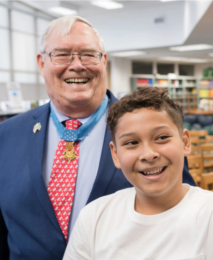 Medal of Honor Recipient and Child smiling