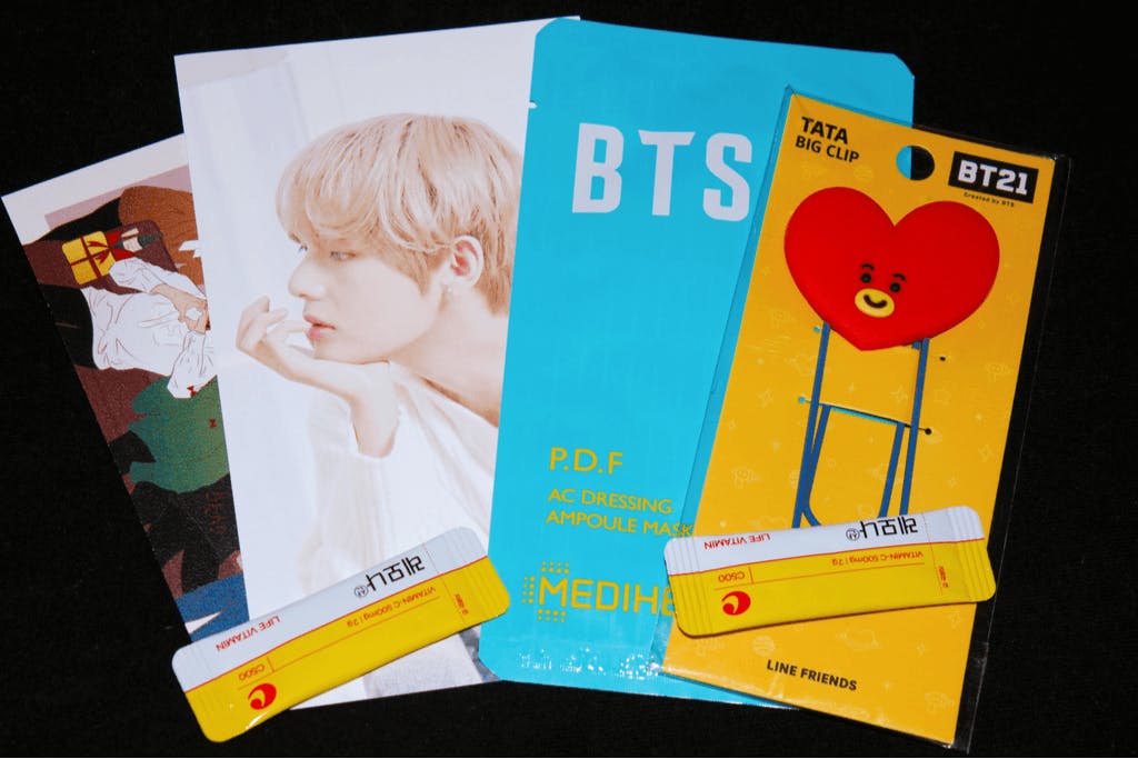 A neat pile of BTS and BT21 products, including one from Mediheal, one of the best Korean Sheet mask makers.
