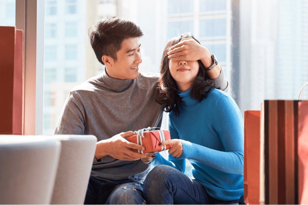 A man covers his girlfriend's eyes while he presents her a present for White Day, a follow-up holiday for Valentine's Day in South Korea.