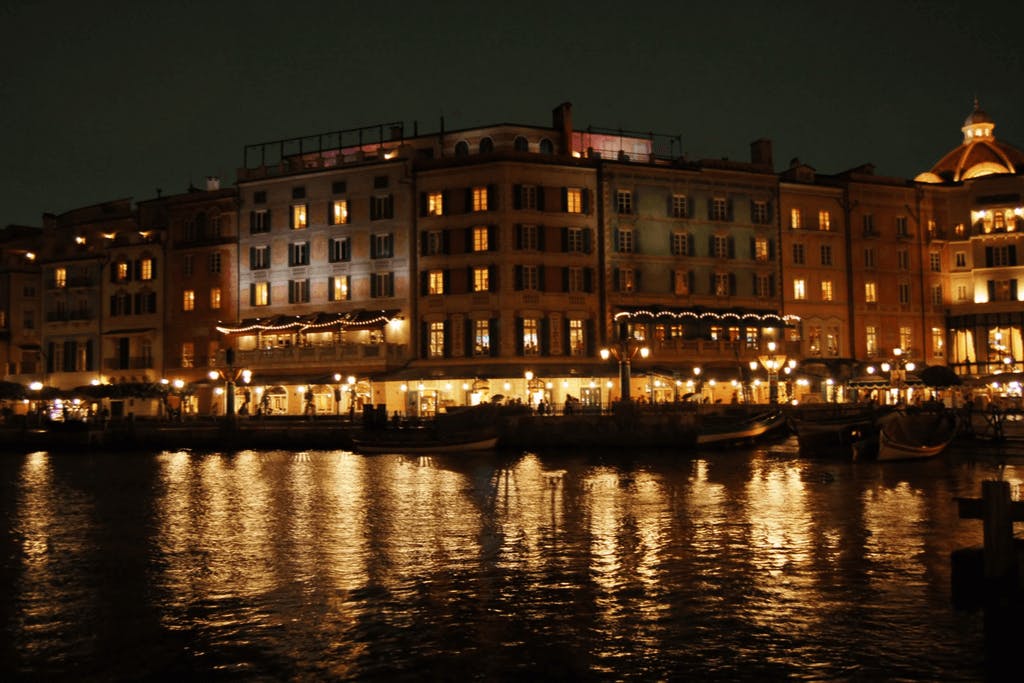 The Mediterranean Harbor of Tokyo DisneySea, a popular Tokyo date spot for couples, at night with many beautiful lights in the buildings around the harbor. 