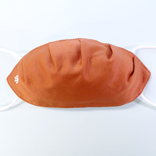 A Japanese face mask shaped like a Japanese gyoza dumpling. 