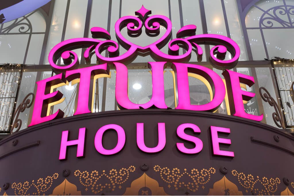 A pink Etude House sign above a store entrance.
