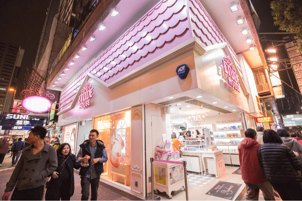 The pink and white storefront of Etude House, a popular Korean beauty brand and maker of a great Korean lip mask, with many people in front of it