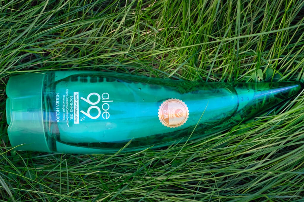 A bottle of Holika Holika's Soothing Aloe Vera 99 Gel on grass