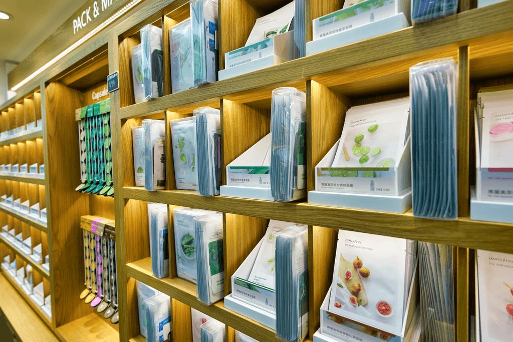 Shelves of Innisfree sheet masks in an Innisfree store, with many of the masks having pictures of different vegetables.