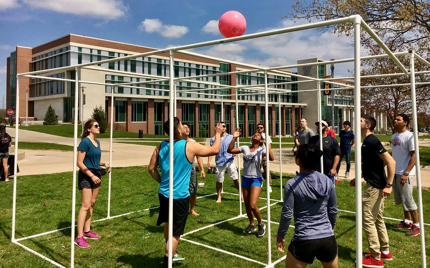 Group of college students playing games on WMU campus.