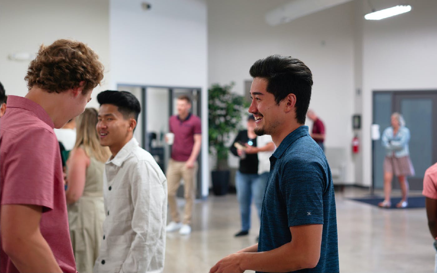 Guys talking in the lobby after service.