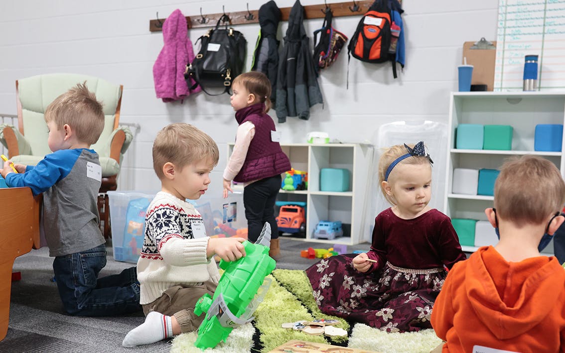 A group of two and three year olds playing together.