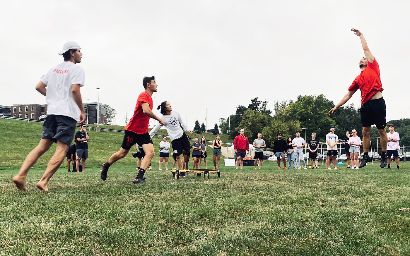 A group of college students playing spike ball on Western Michigan's campus.