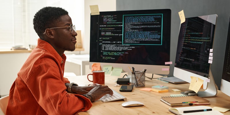 Man working remotely at a desk at his computer
