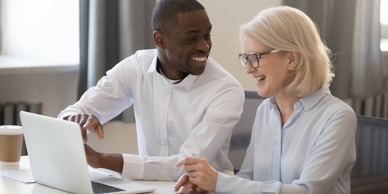 man and woman sitting at a laptop