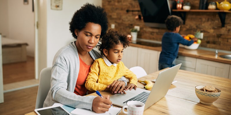mother with two kids working at laptop
