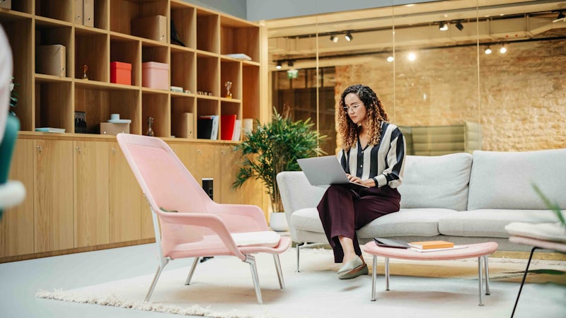 Woman looking at laptop in office space