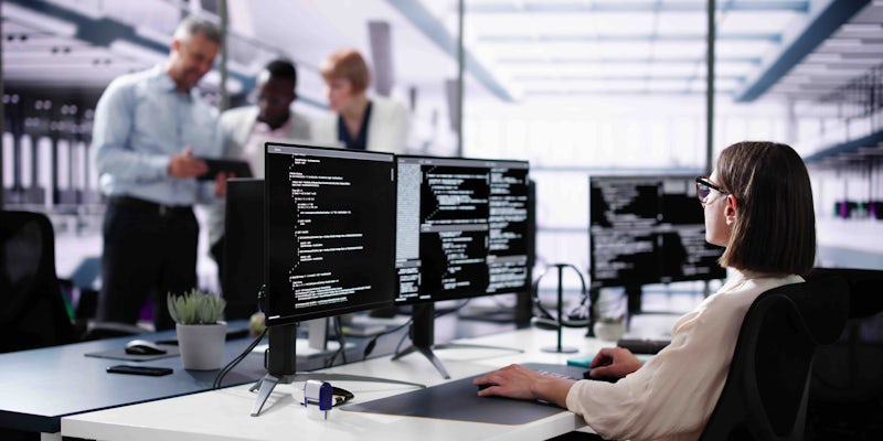 Female programmer looking at code