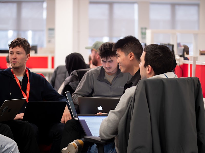 A group of Northcoders student coding on their laptops