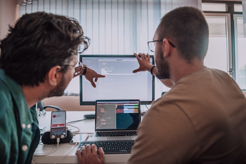 Two people design testing at computer