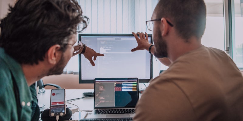 Two People design testing at computer