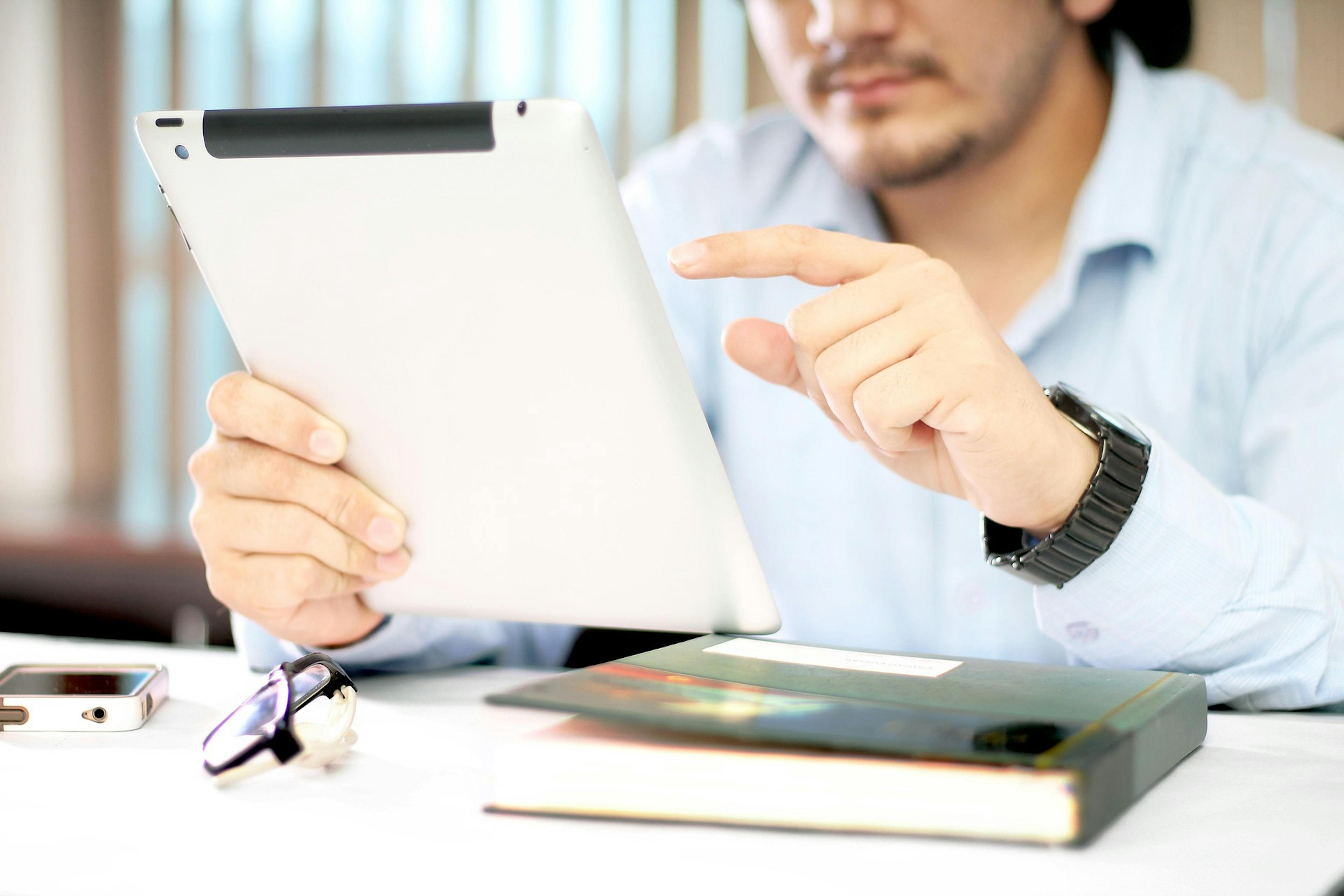 person setting goals on an ipad