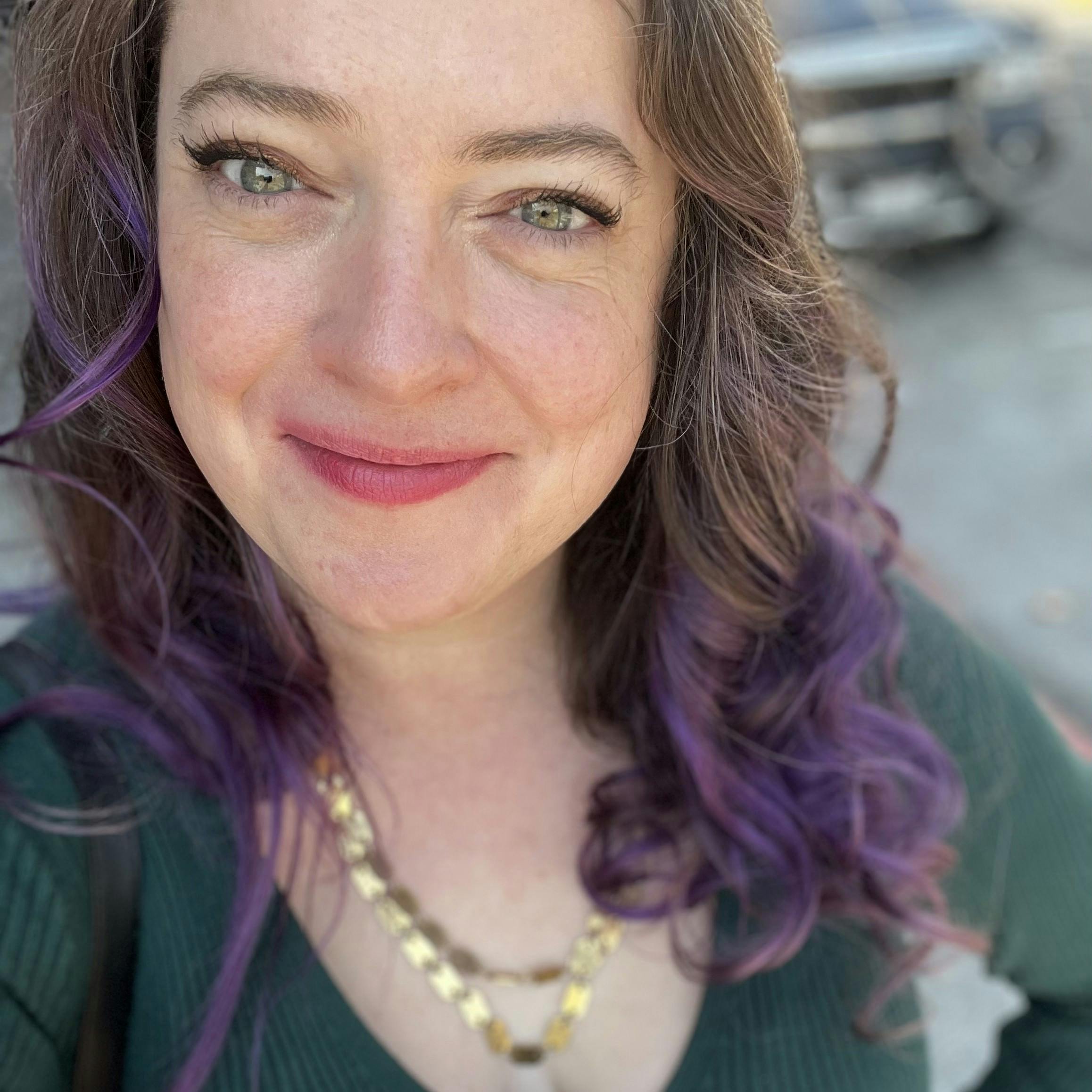 Profile photo of Margaret H. Willison, with touches of purple in her brown hair 