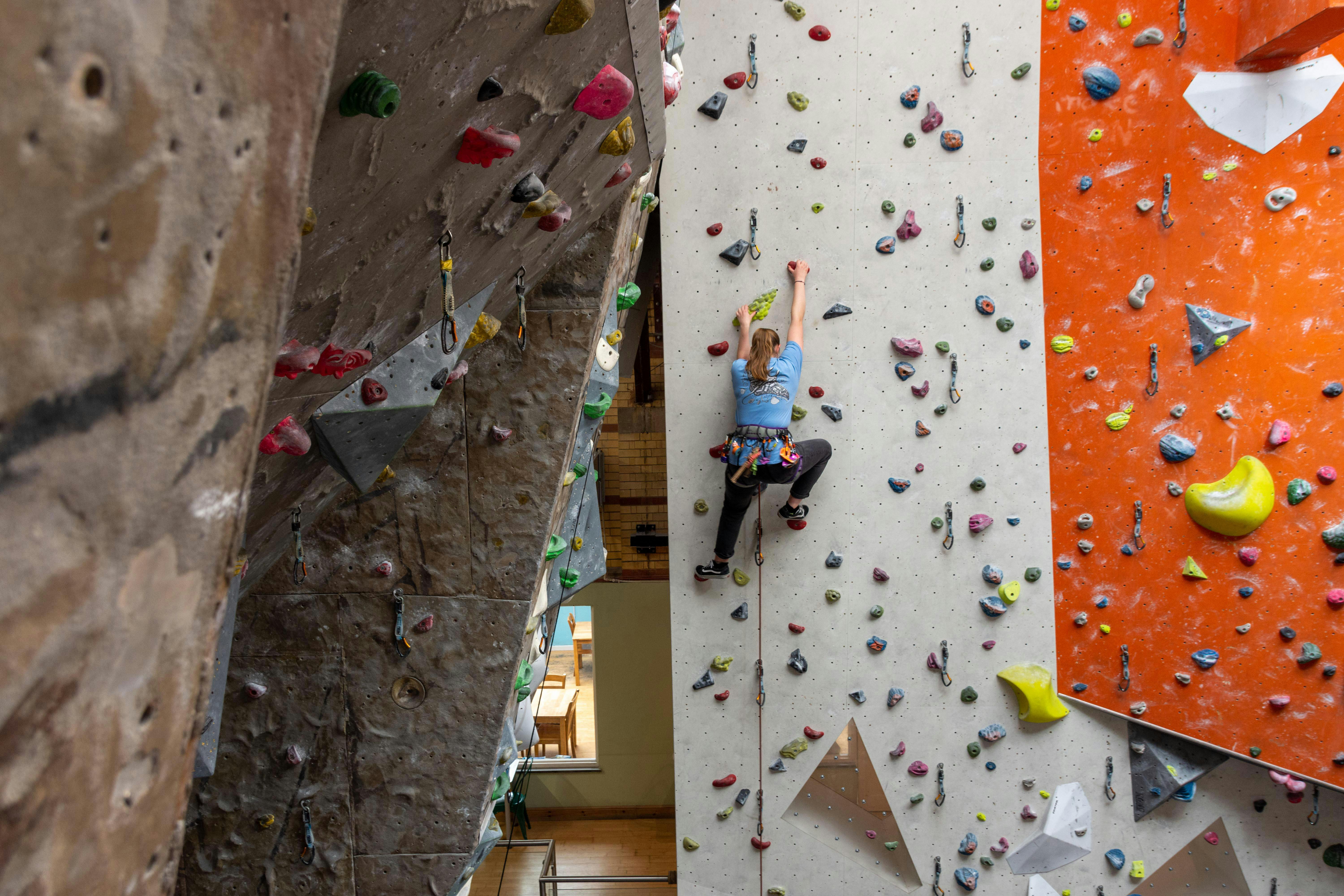 Climber on a roped climbing wall