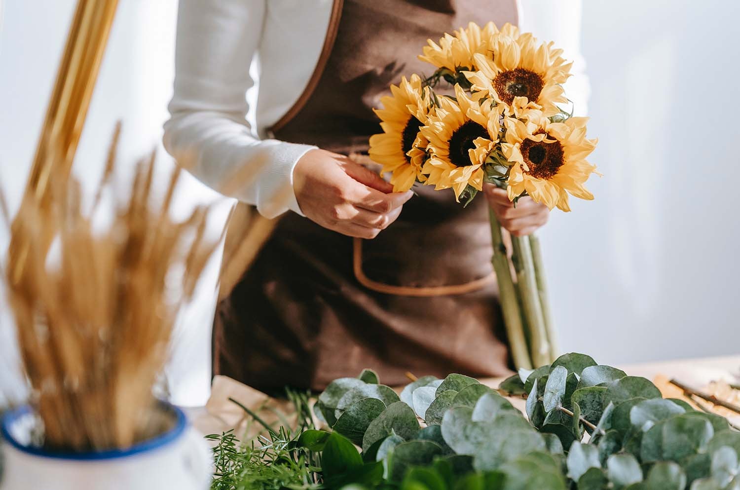 Young Woman Arranging Sunflowers