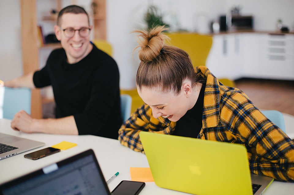Agency team laughing in an office