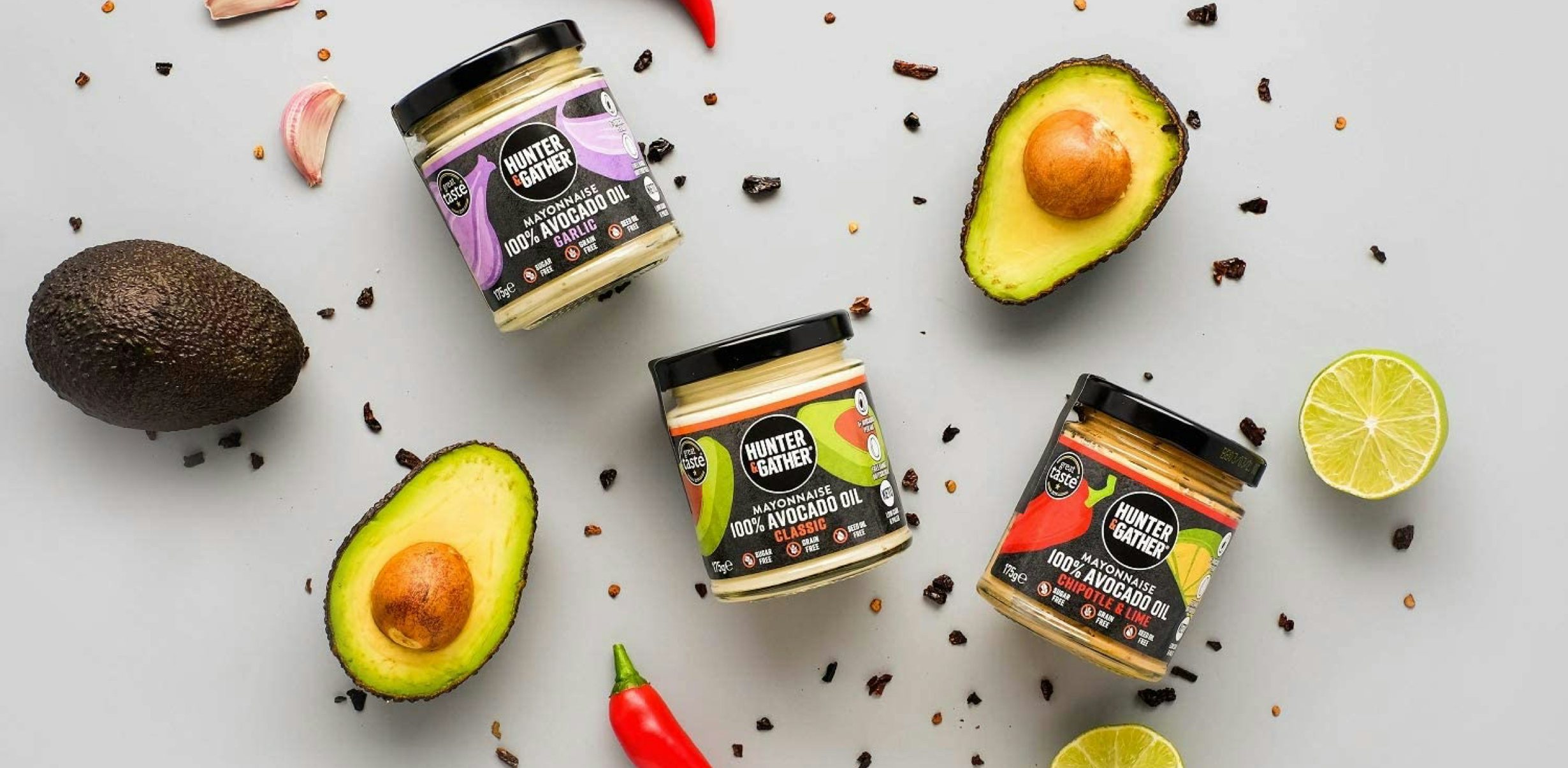 Product shot of Hunter & Gather avocado oil with fresh avocados and red chillies