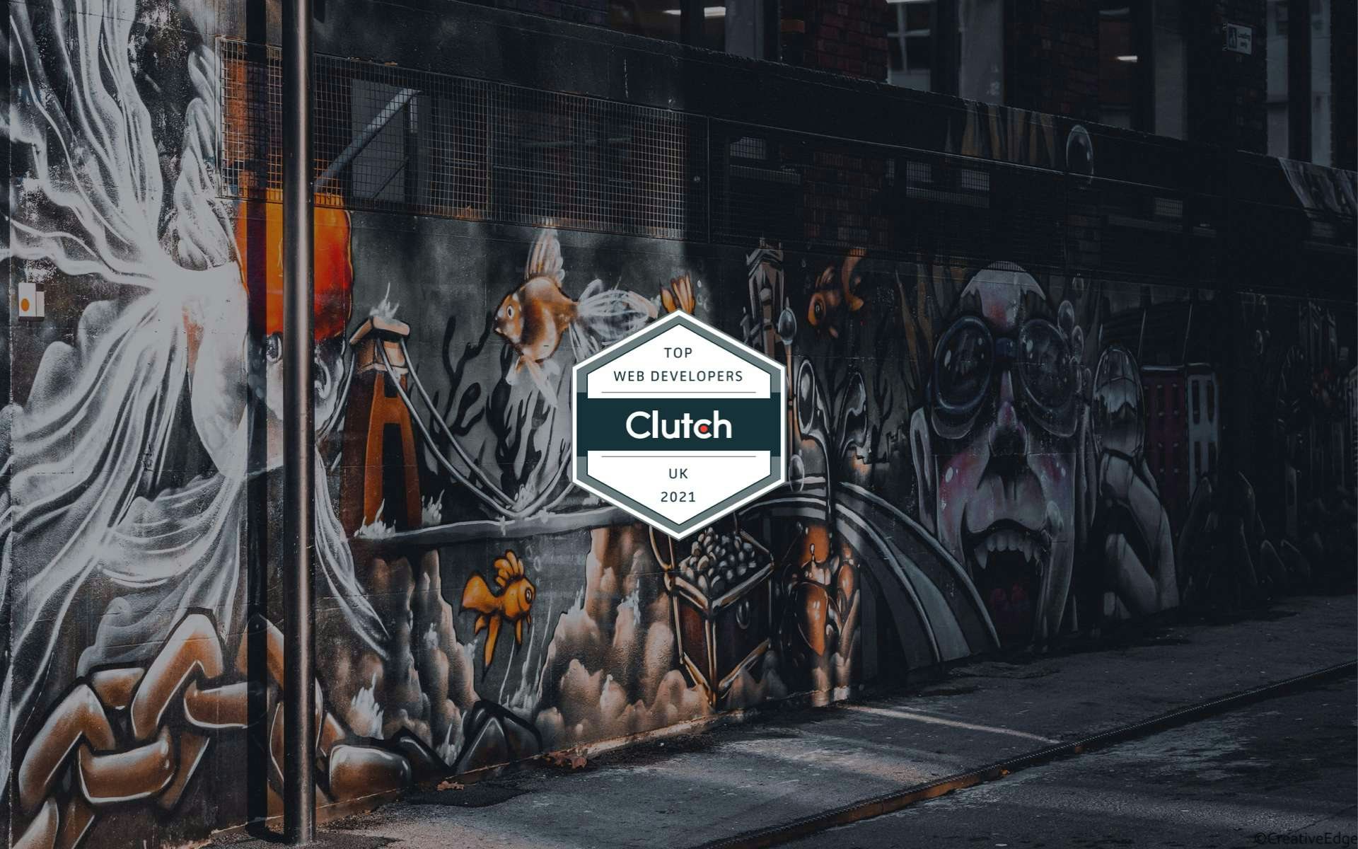 Clutch Leader award against a graffitied wall