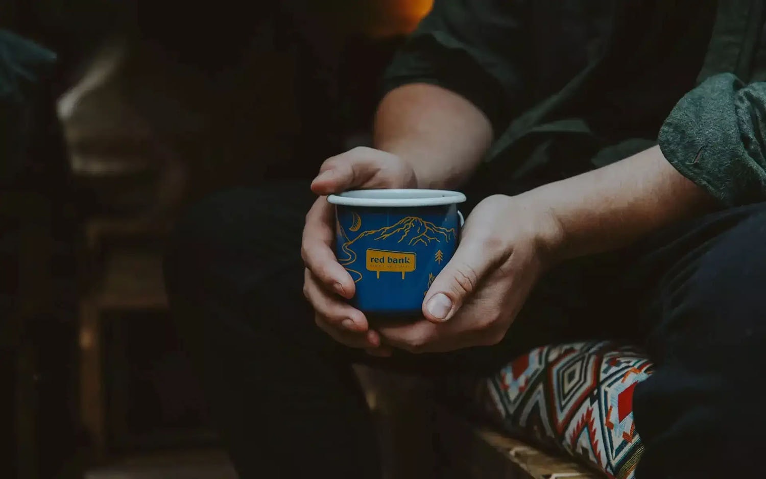 Man holding red bank coffee enamel mug