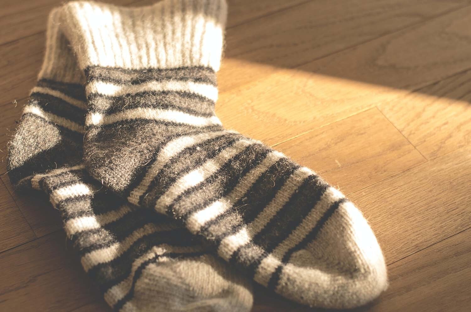 Pair of wooly socks on a wooden table