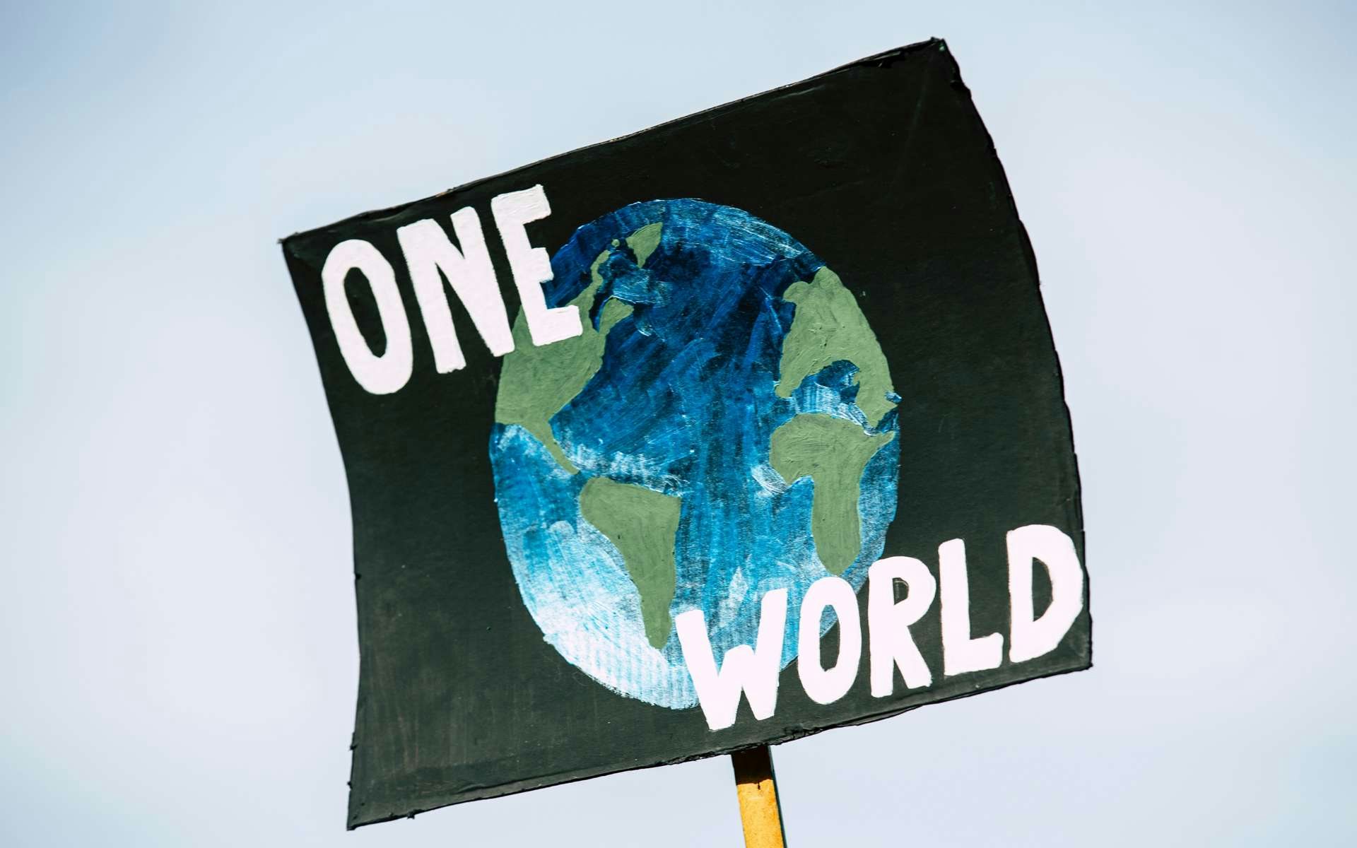 Banner with picture of the earth and the words 'one world' 