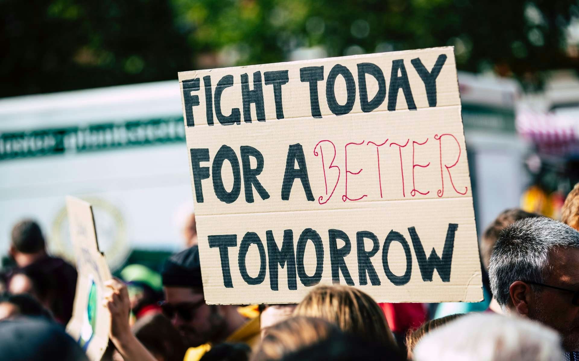 Banner in a crowd which reads 'fight today for a better tomorrow'