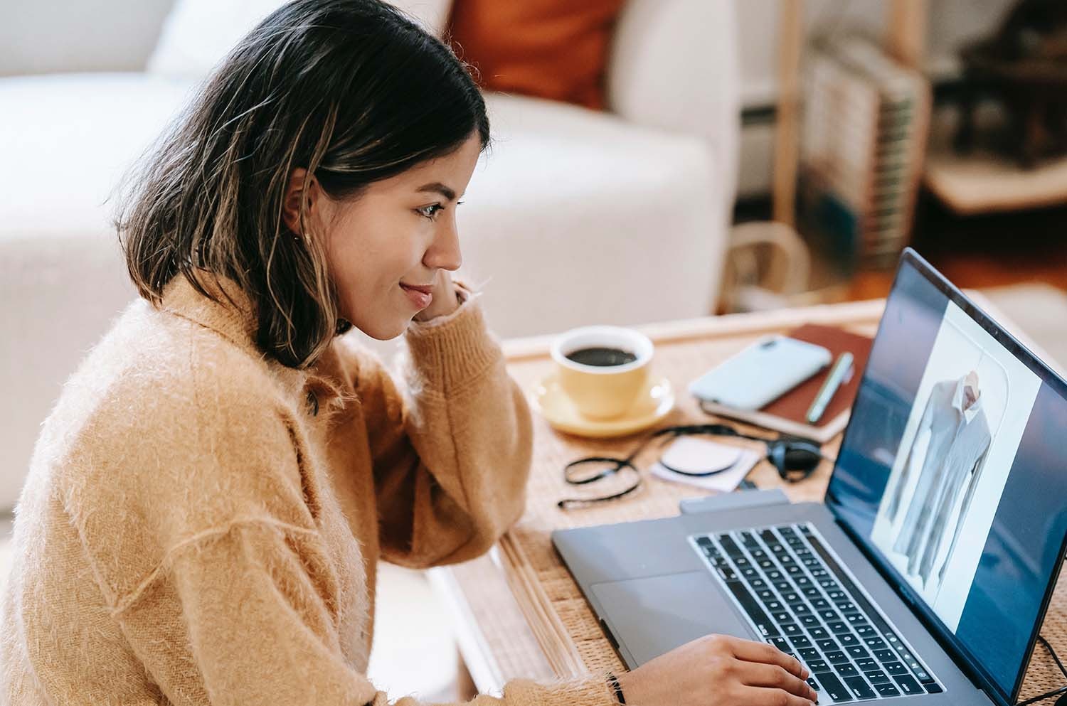 Young Woman Editing Product Images on a Laptop