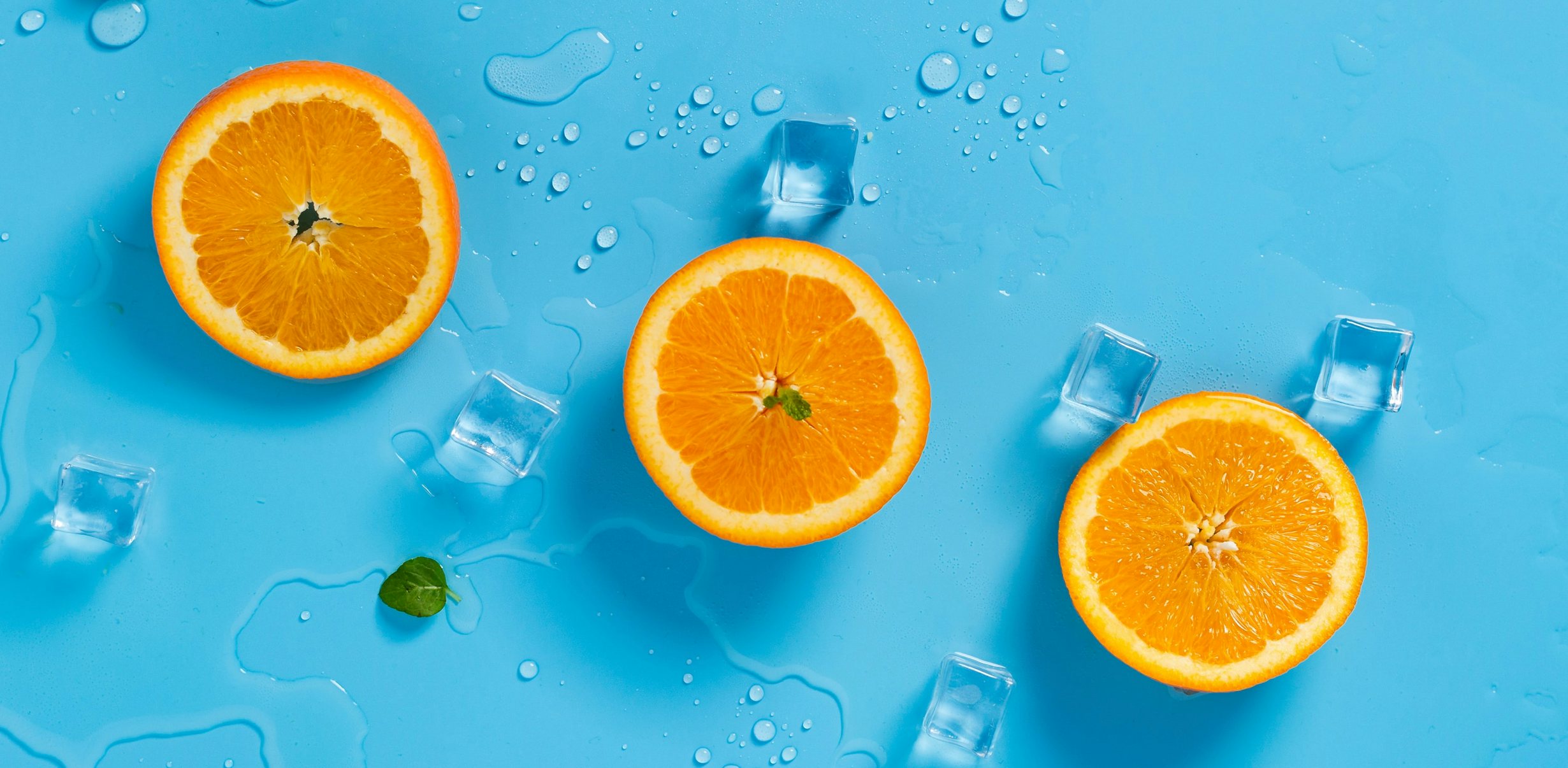Overhead image of super fresh orange slices and cooling ice cubes