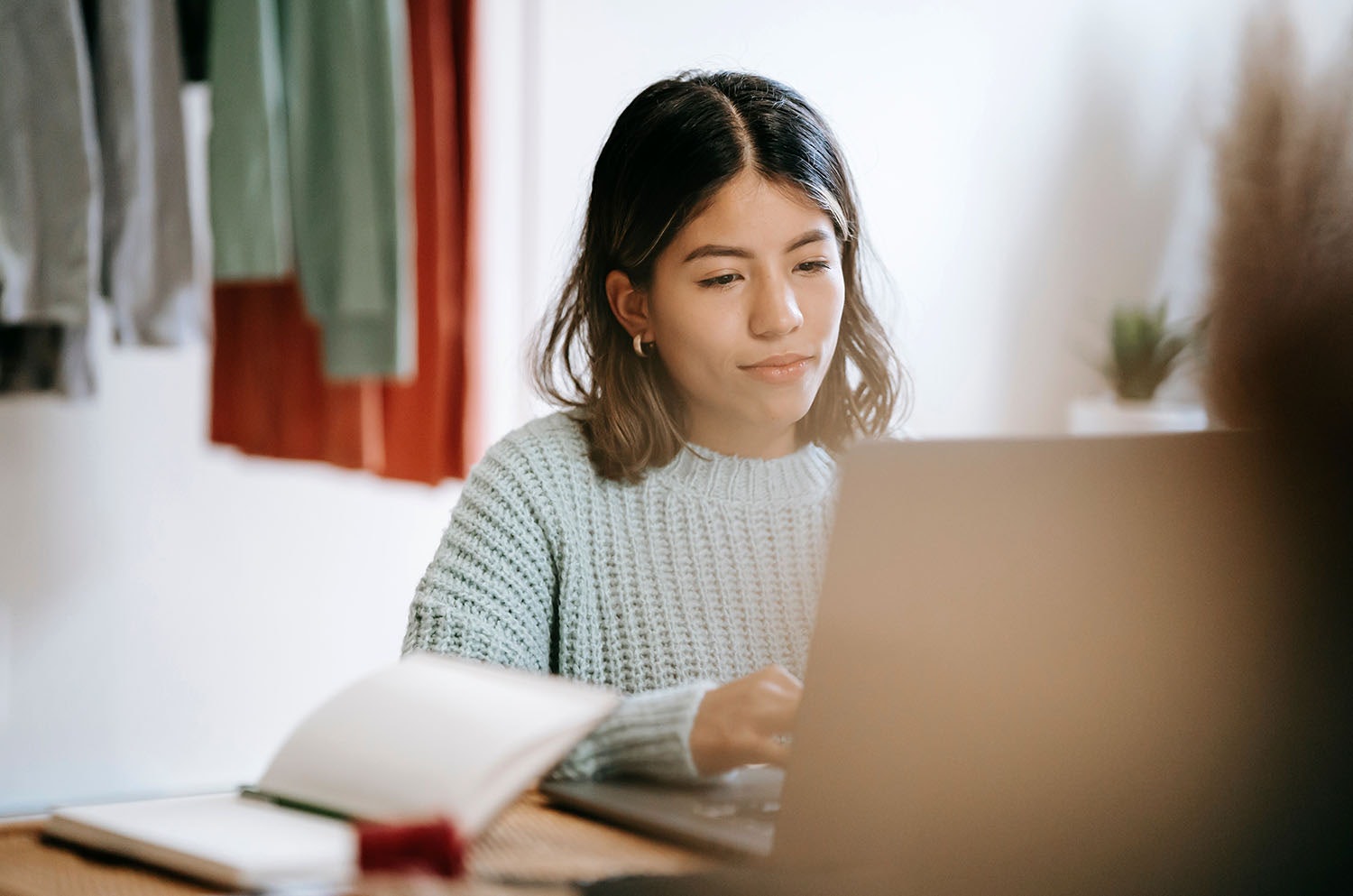 Young Woman Optimising Website SEO at a Laptop