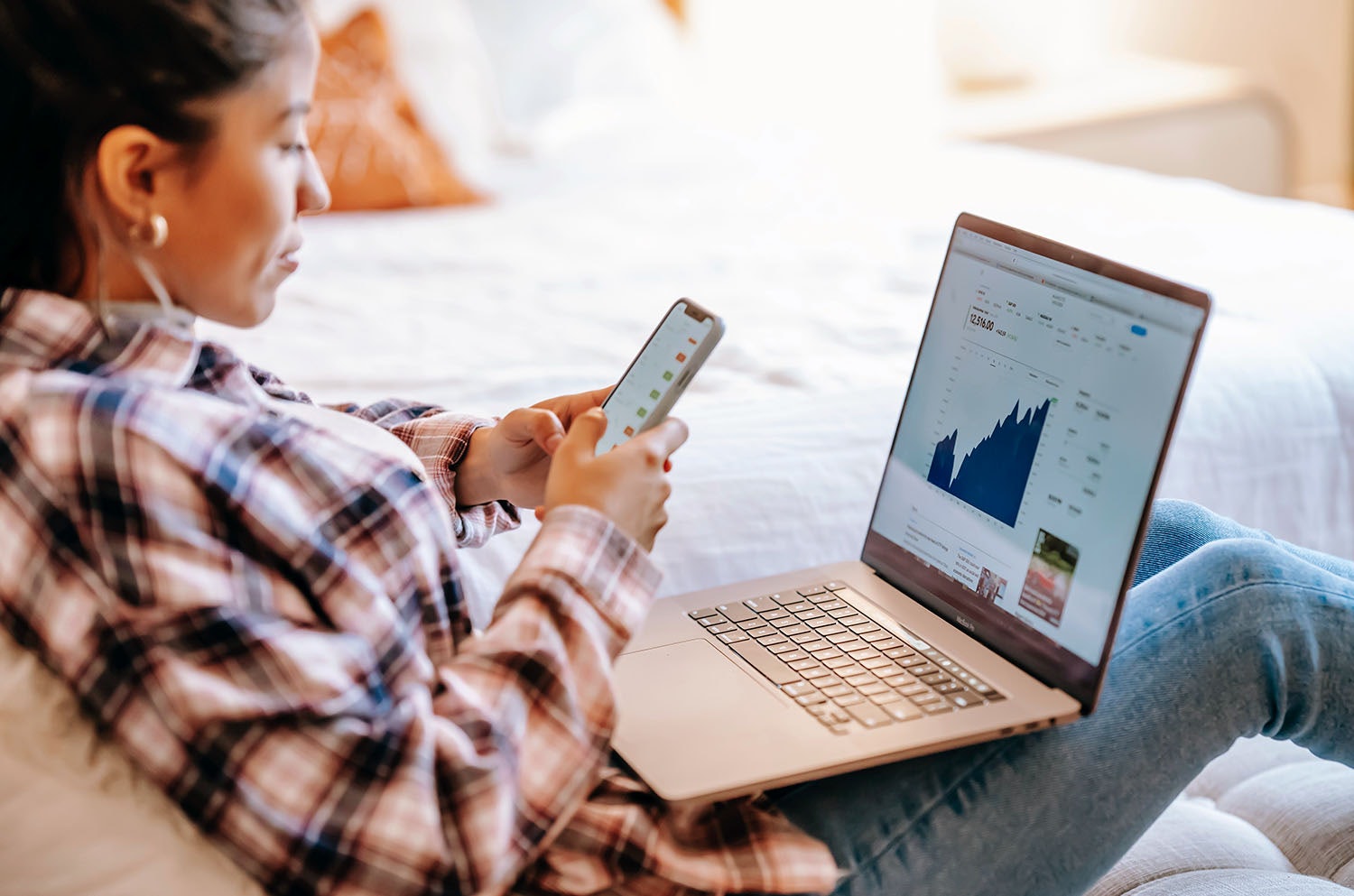 Young Woman Looking at Website Analytics on a Laptop