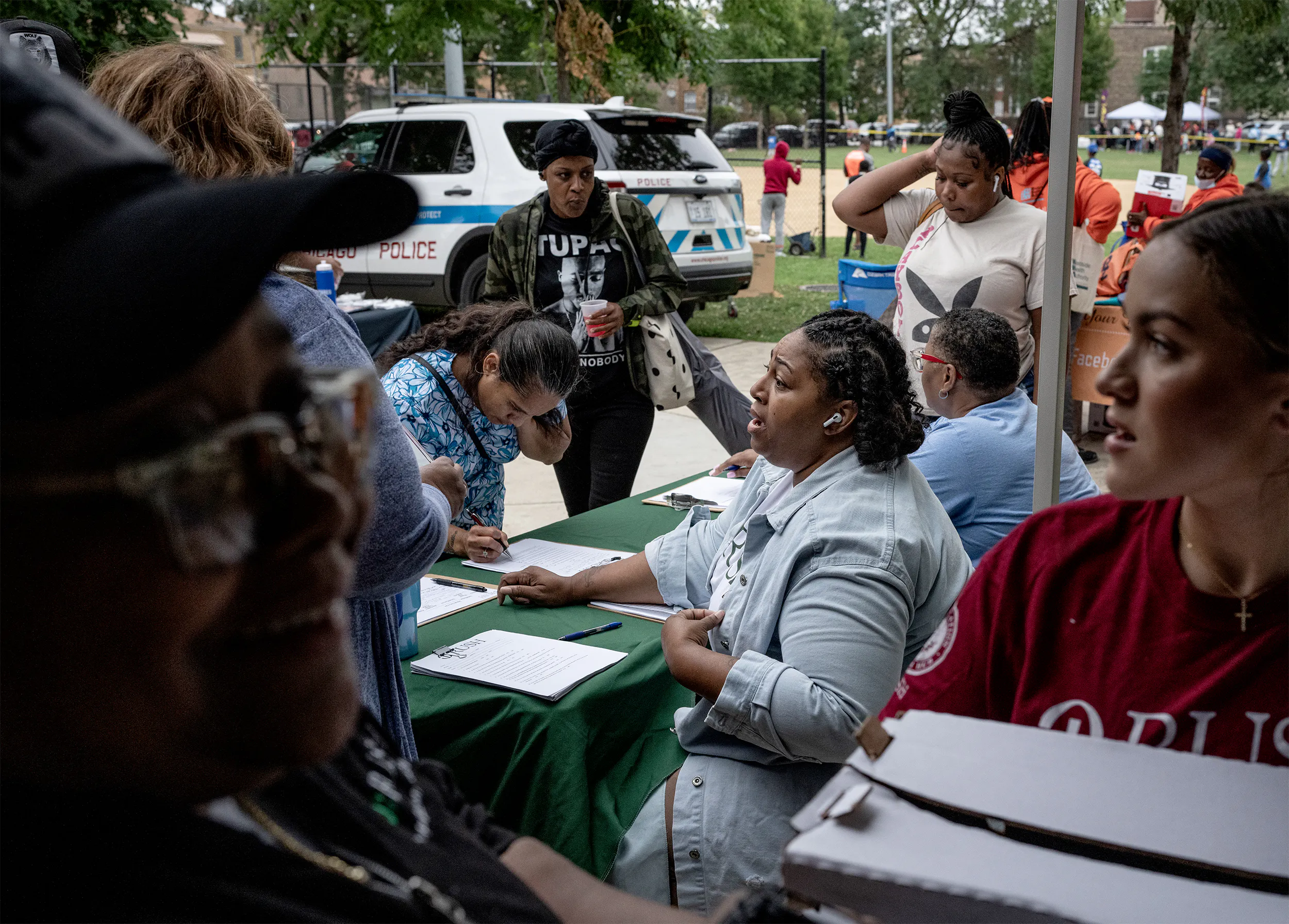 Q and other Rush employees distributing food packages at Maurice Park in the center of West Side Chicago.