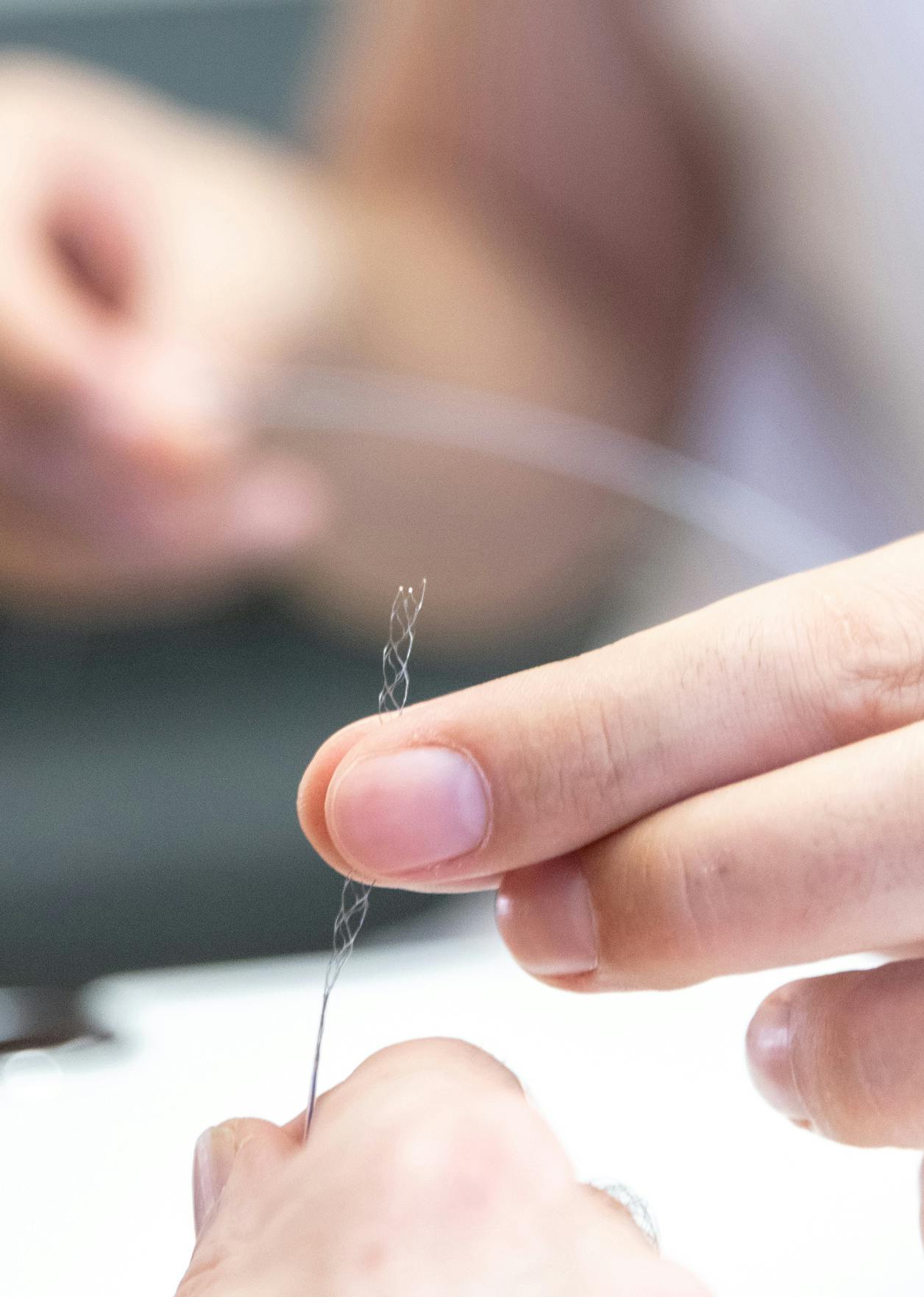 Marios Psychogios shows tiny surgical equipment.