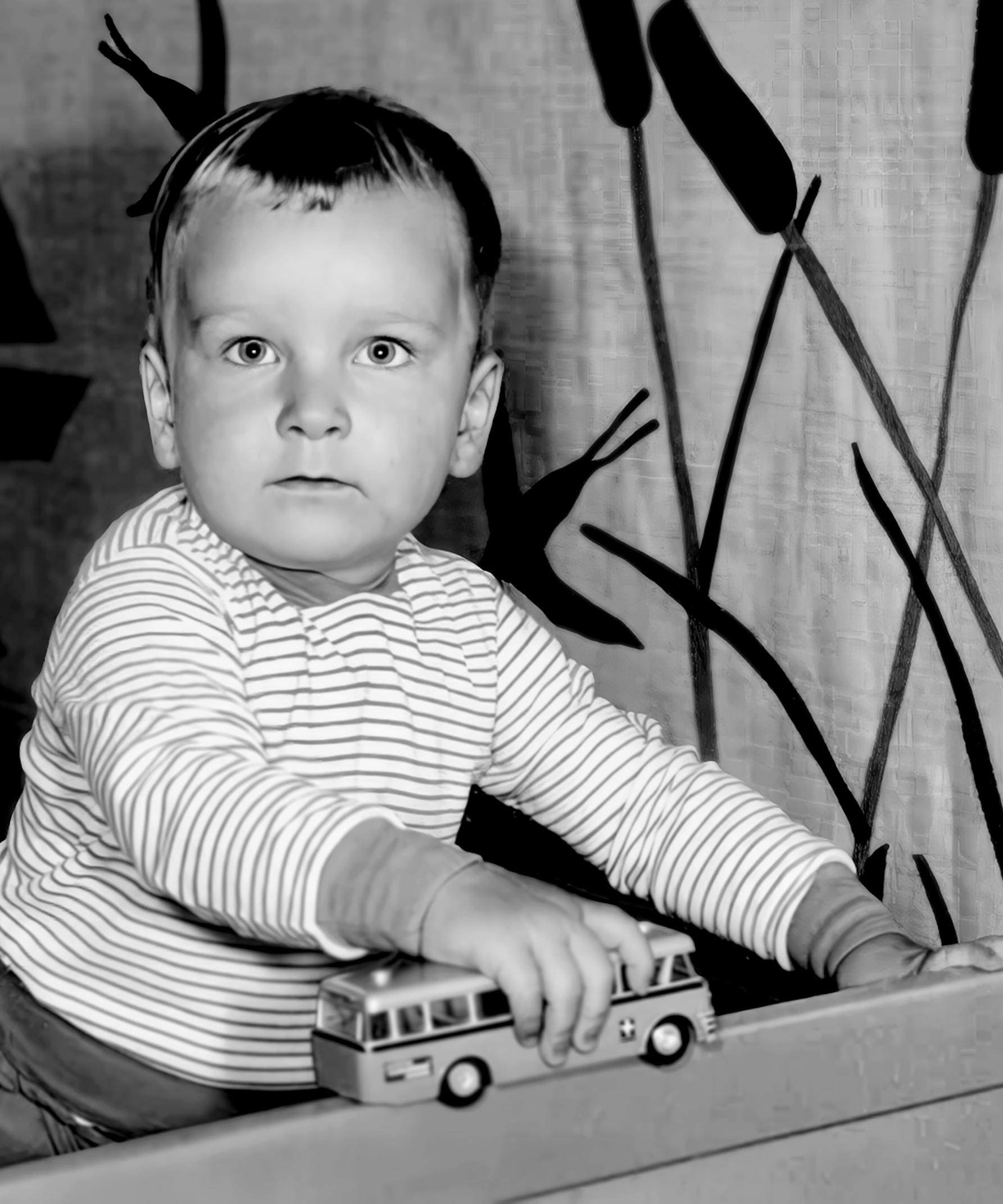 Martin Duerr as a toddlerplaying with a car toy – black-and-white.